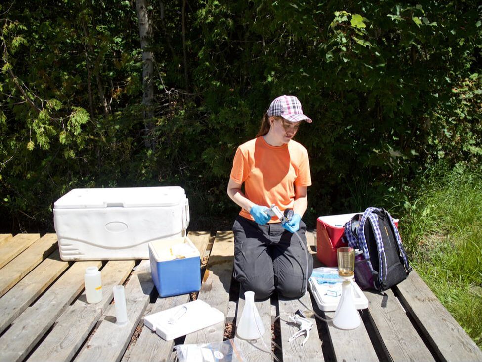 A student with all her sampling equipment on a dock